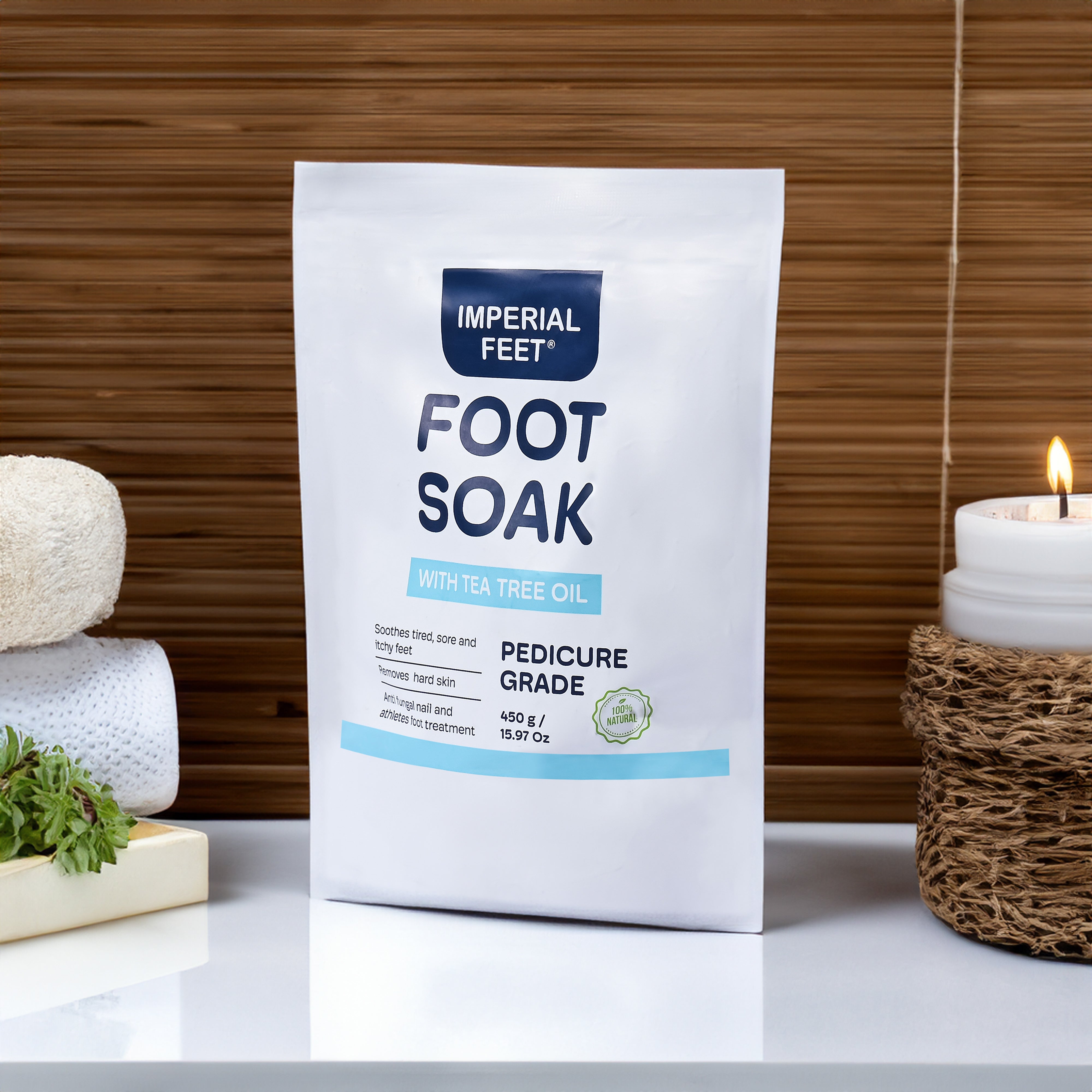 Imperial Feet Foot Soak with tea tree oil displayed in a spa setting with candle and towels.