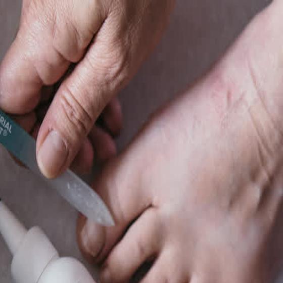 Filing the nail thin with the glass file